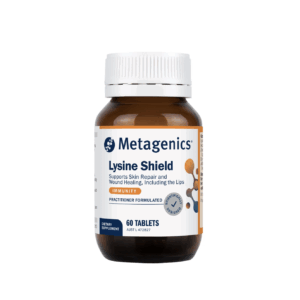 A brown bottle labeled "Metagenics Lysine Shield" contains 60 tablets. The label states it supports skin repair and wound healing, including the lips, and is practitioner formulated for immunity.